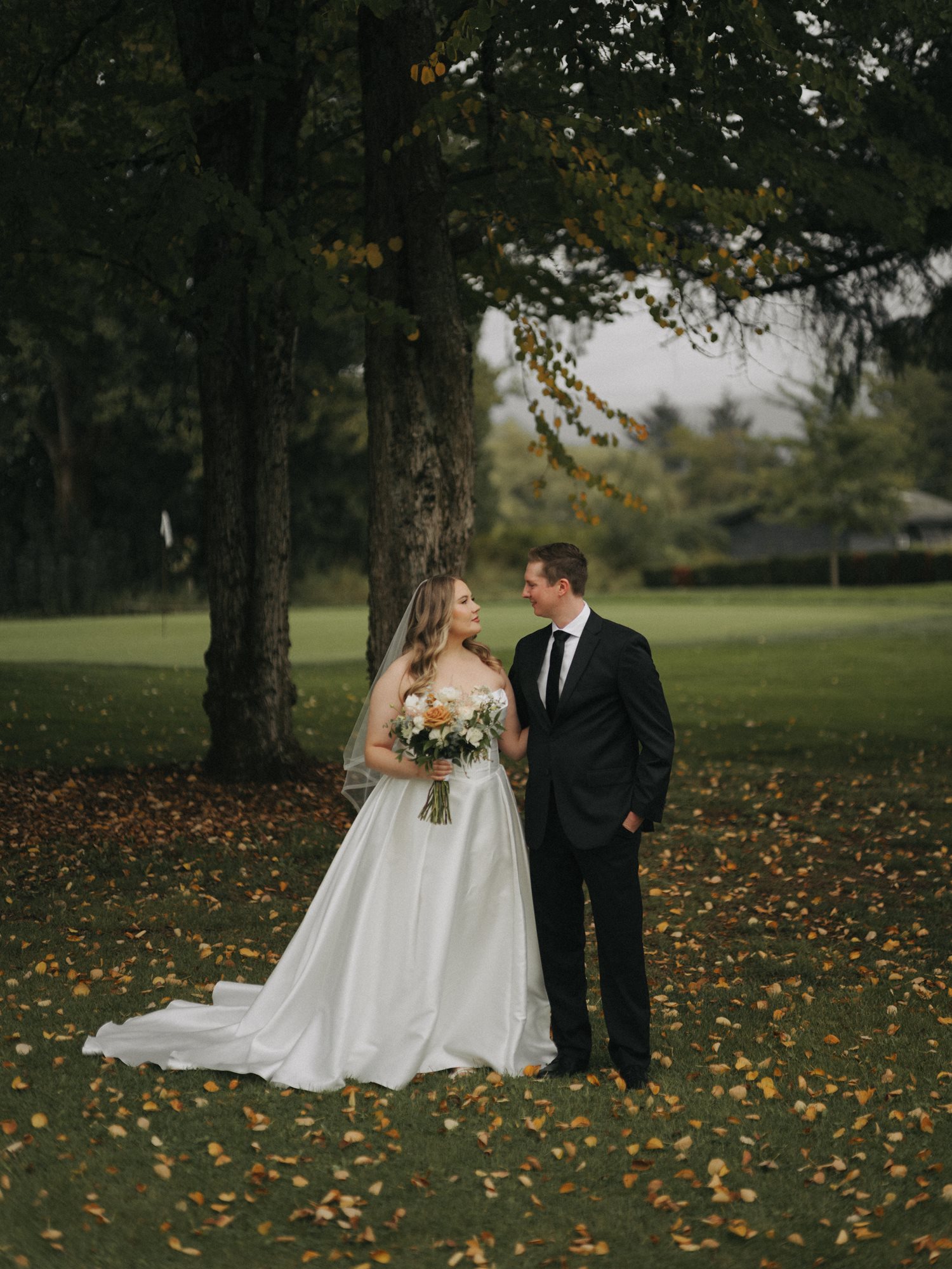 Bride and groom under trees