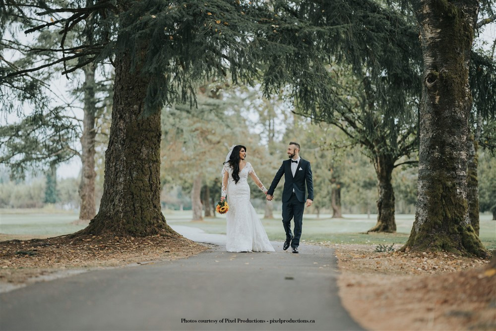 A-wedding-couple-walking-hand-in-hand-Pitt-Meadows-Golf-Club